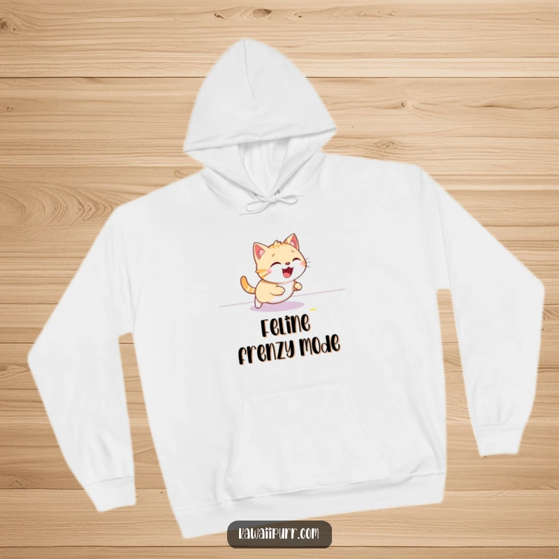 Funny cat hoodie, giggling gleefully while chasing a red laser dot on the floor, perfect for cozy, playful days.