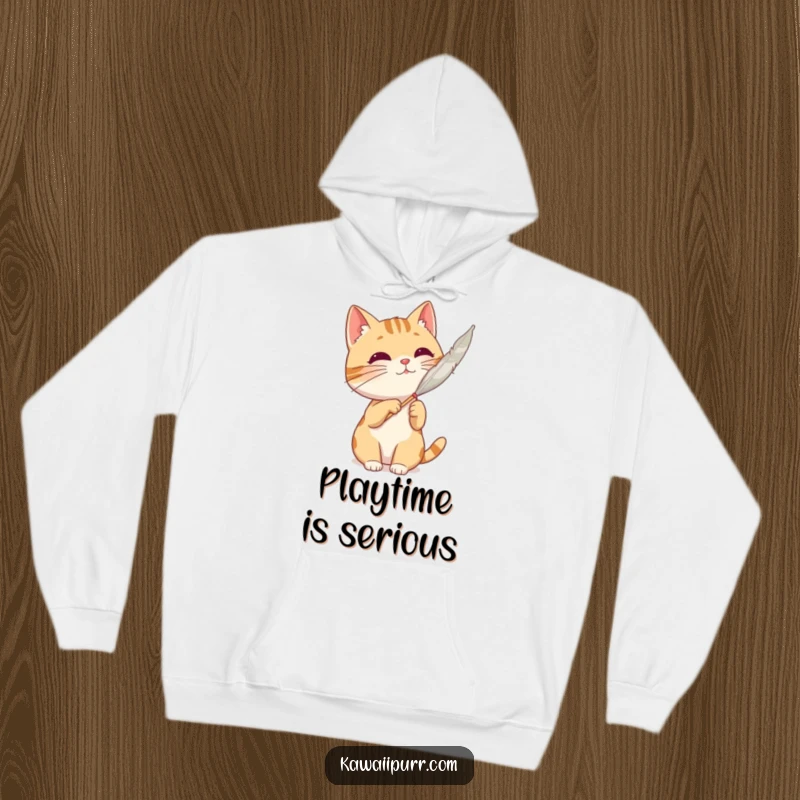 Funny cat character actively batting at a feather, captured on a soft and cozy hoodie.