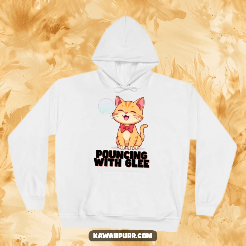Funny hoodie featuring a ginger cat wearing a tiny bowtie, joyfully batting at a floating bubble.