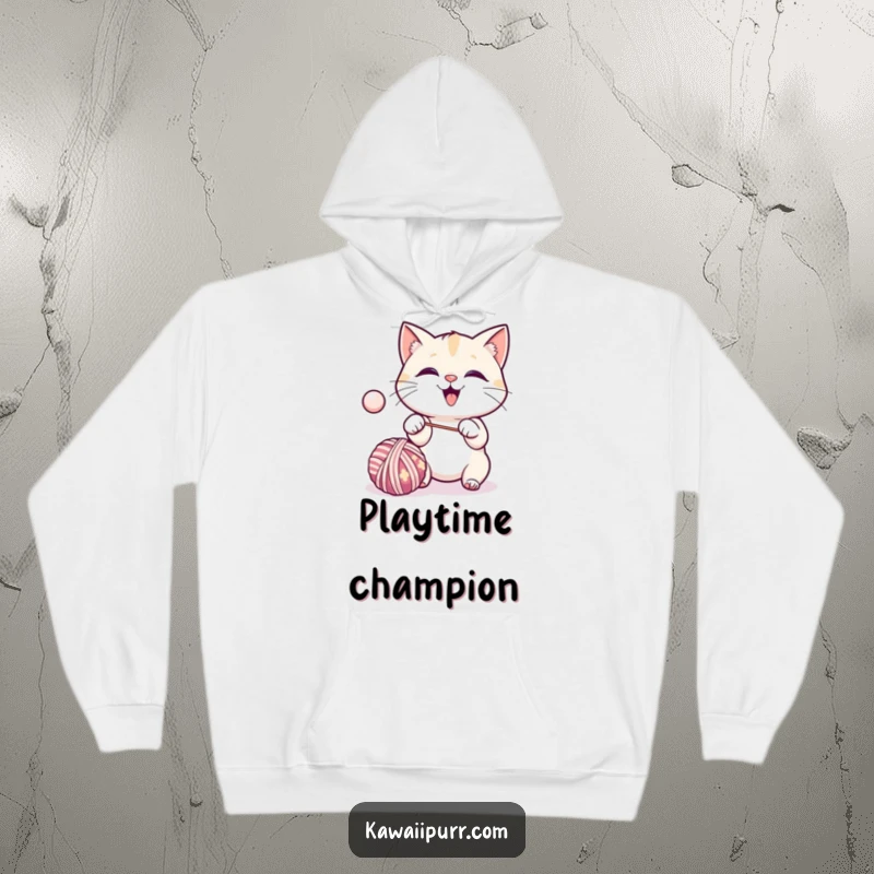 Funny kawaii cat excitedly batting a bouncing ball of yarn, cozy in a hoodie.