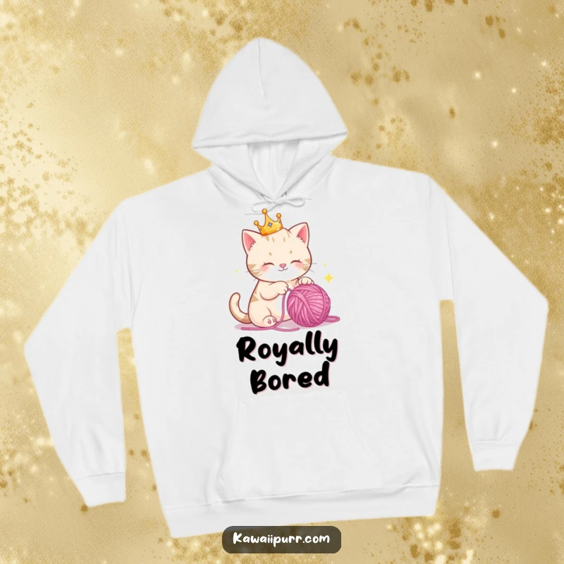 Funny Hoodie: A majestic cat adorned with a small crown, playfully engaging with a shimmering ball of yarn, radiating happiness.
