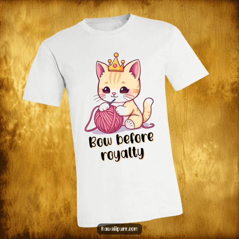 Funny t-shirt featuring a charming kawaii cat adorned with a tiny crown, hilariously engaged in batting a playful ball of yarn.