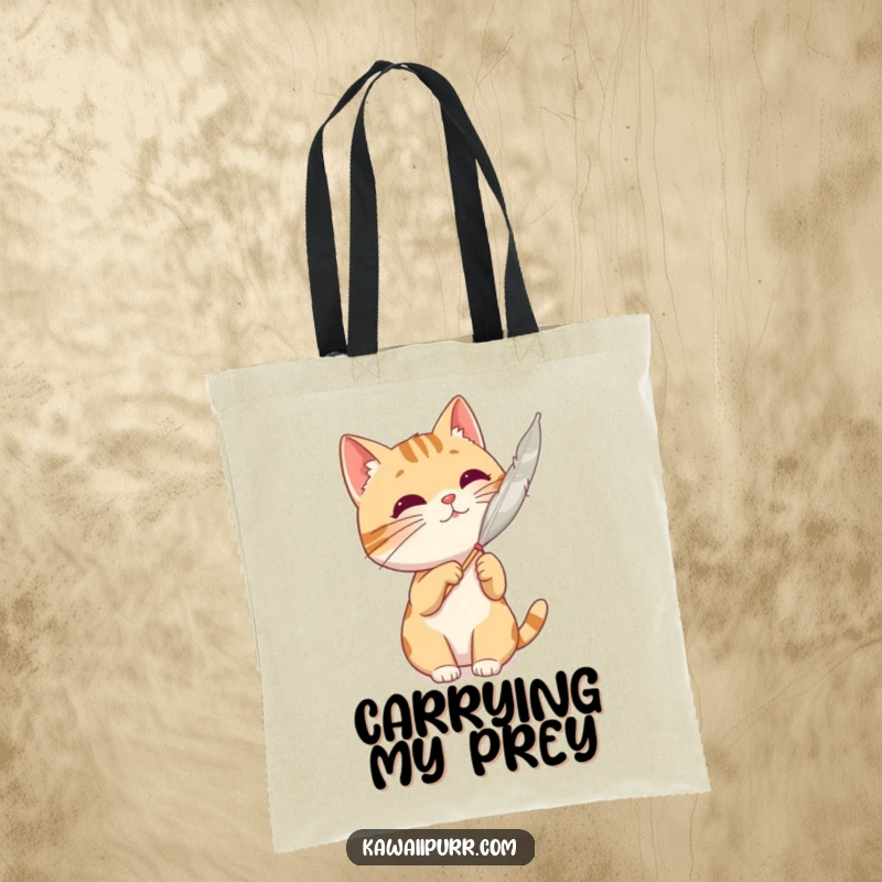 Funny cat character batting at a floating feather, designed on a versatile and stylish tote bag.