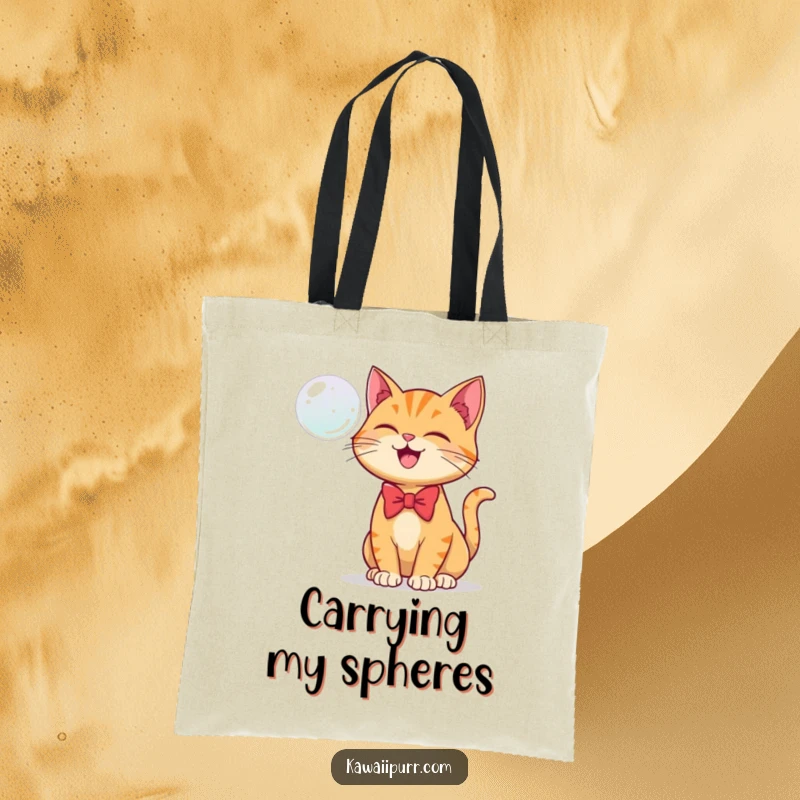 Funny tote bag with a ginger cat in a bowtie joyfully batting at a floating bubble.