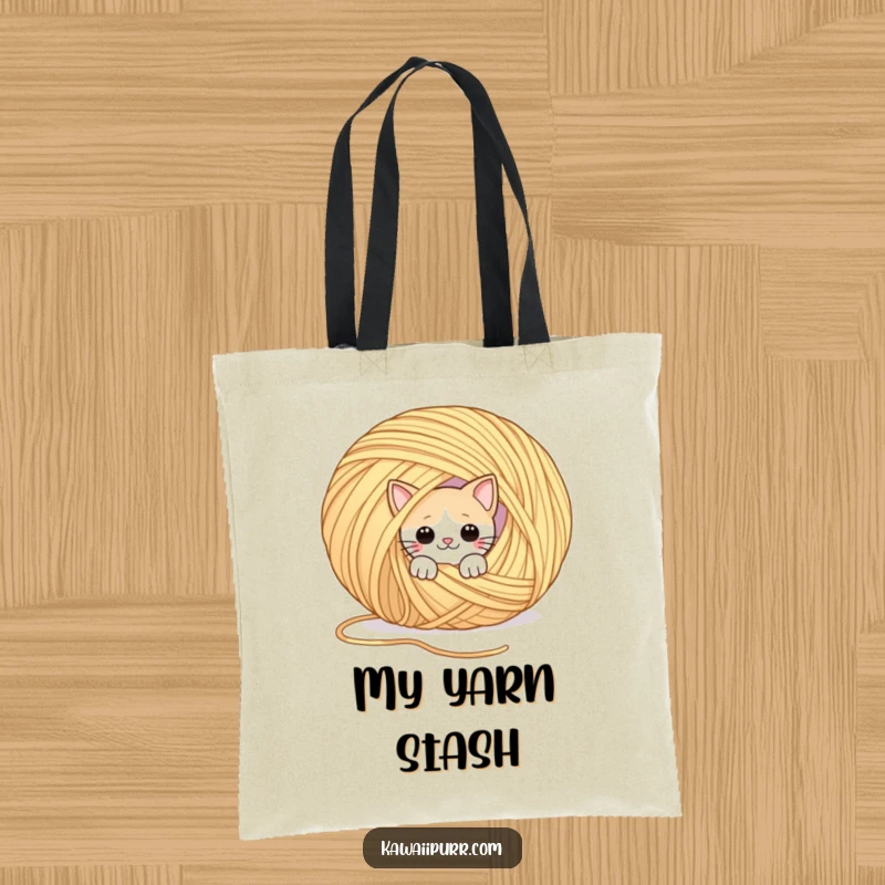 Funny tote bag featuring a playful cat peeking out from behind a giant ball of yarn. Perfect for carrying playful surprises.
